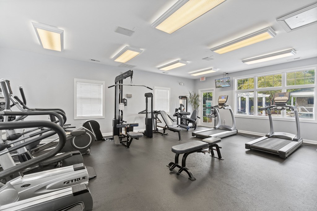 a gym with treadmills and other exercise equipment and windows at Saltmeadow Bay, Virginia Beach, VA