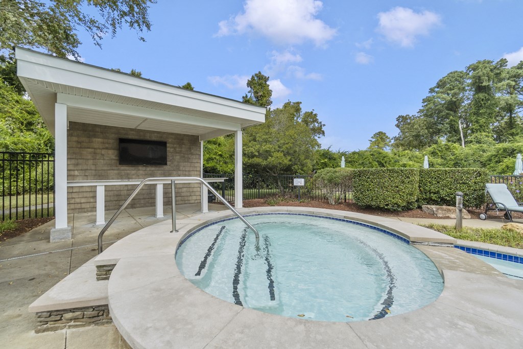 a hot tub and pool in a backyard with a pool house at Saltmeadow Bay, Virginia Beach
