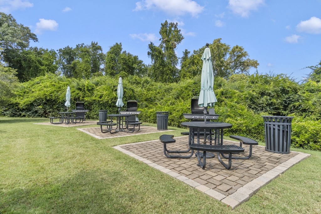 a patio with tables and umbrellas in a park at Saltmeadow Bay, Virginia Beach, 23451