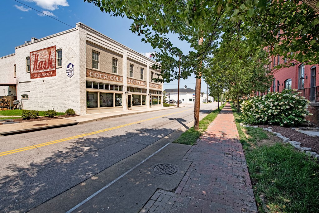 a city street with a building and trees on the side of it at Mayton Transfer Lofts in Petersburg, 23803