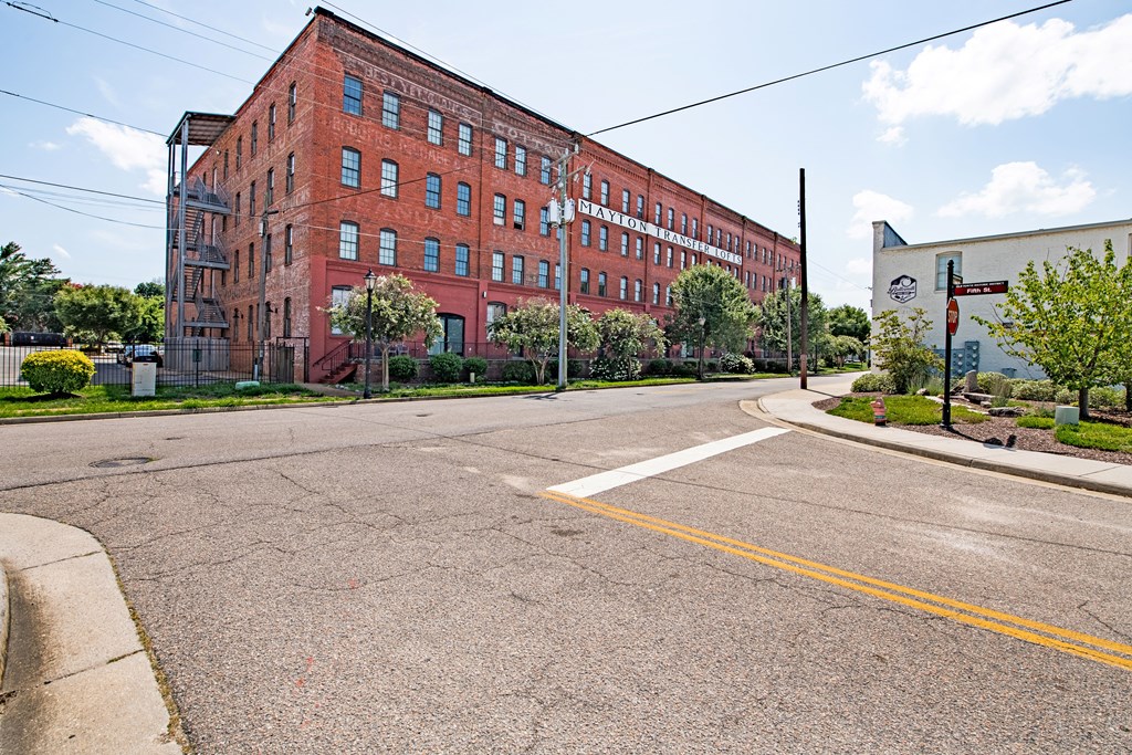 an empty street in front of a red brick building at Mayton Transfer Lofts in Petersburg, VA