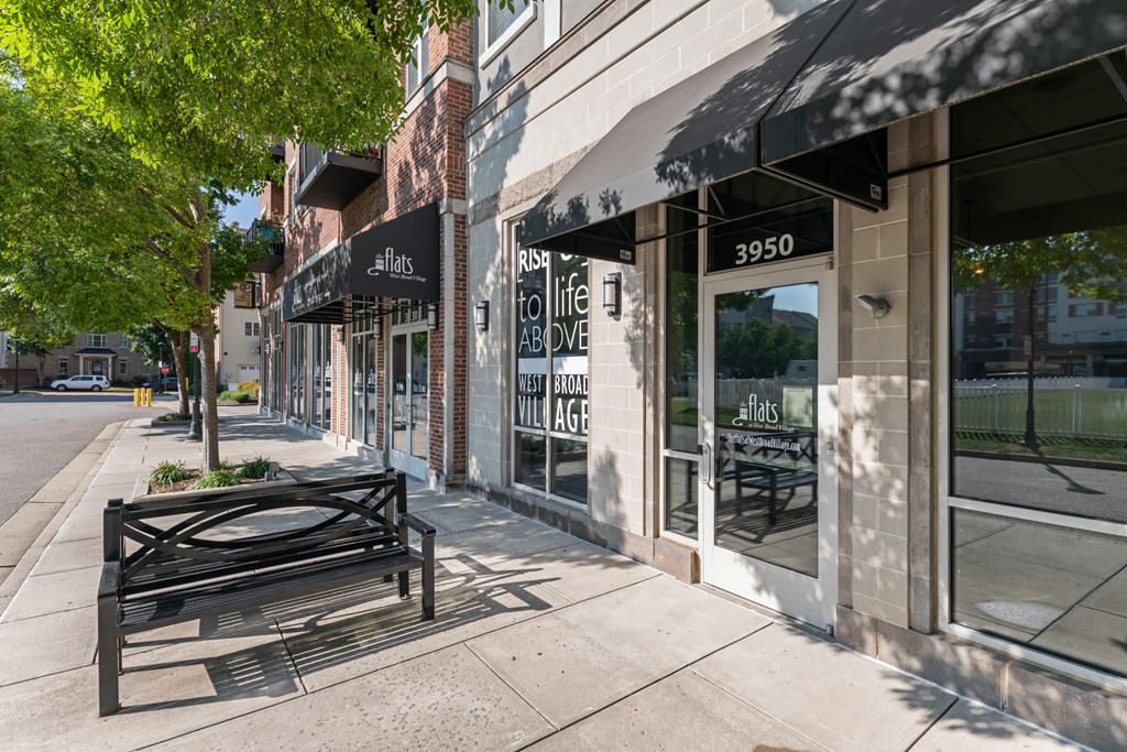 a bench on a sidewalk in front of a building