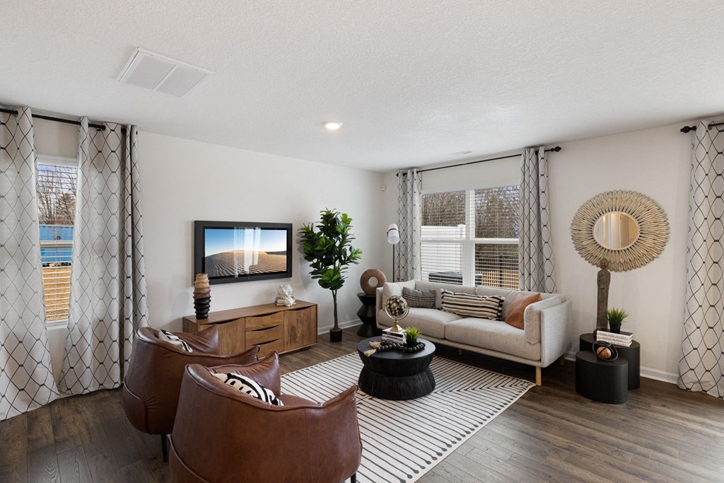 a living room with a couch and a tv a living room with a couch and a tv at Summit Place Apartments, Oak Ridge, Tennessee