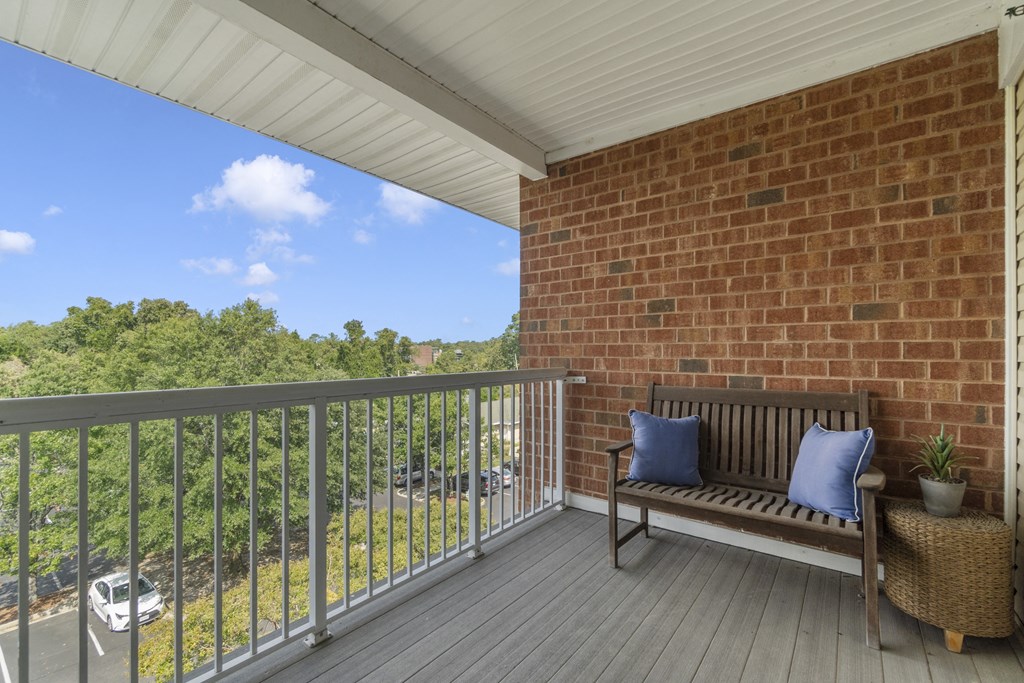 a porch with a bench and a brick wall at Saltmeadow Bay, VA, 23451