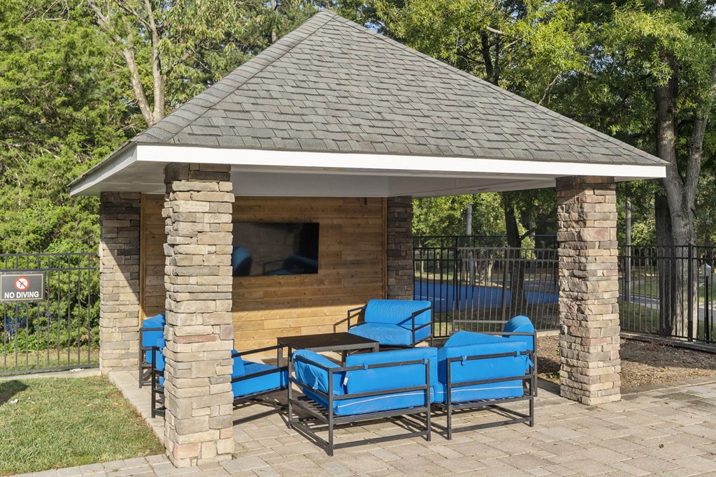 a pavilion with a table and chairs in front of a pool at Trails at Short Pump Apartments, Richmond, VA, 23233