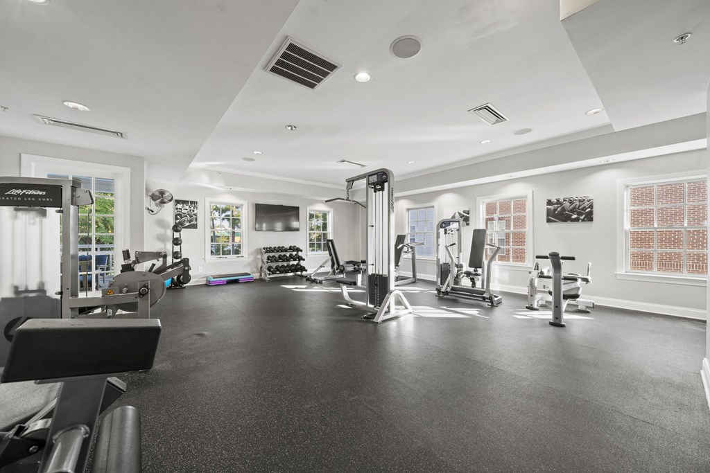 A black and white photo of a gym with various exercise equipment  at Sterling Manor, Williamsburg, VA
