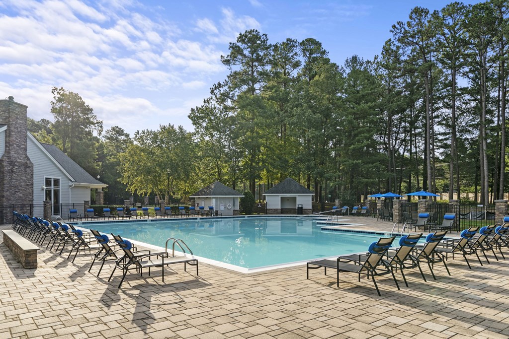 our resort style swimming pool is surrounded by lounge chairs at Trails at Short Pump Apartments, Richmond, Virginia