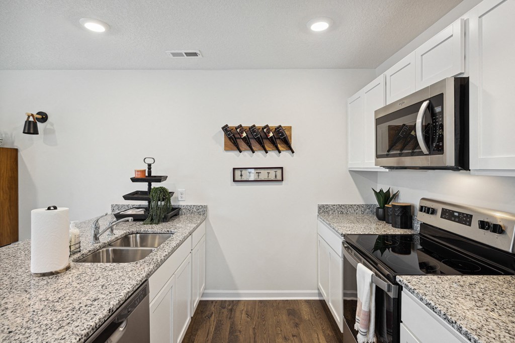 a kitchen with granite counter tops and stainless steel appliances a kitchen with granite counter tops and stainless steel appliances at Summit Place Apartments, Oak Ridge, TN