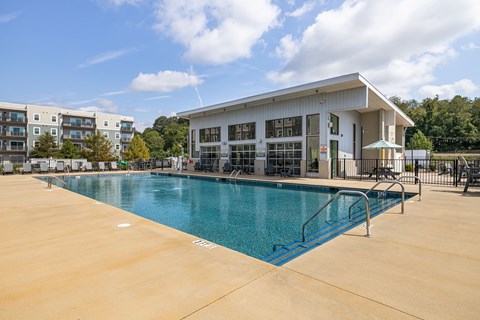 A large swimming pool in front of a building.