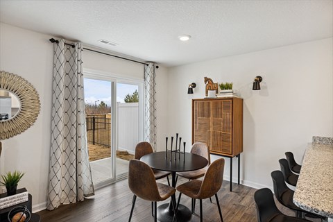 our apartments offer a dining room with a table and chairs and a balcony at Summit Place Apartments, Oak Ridge, Tennessee