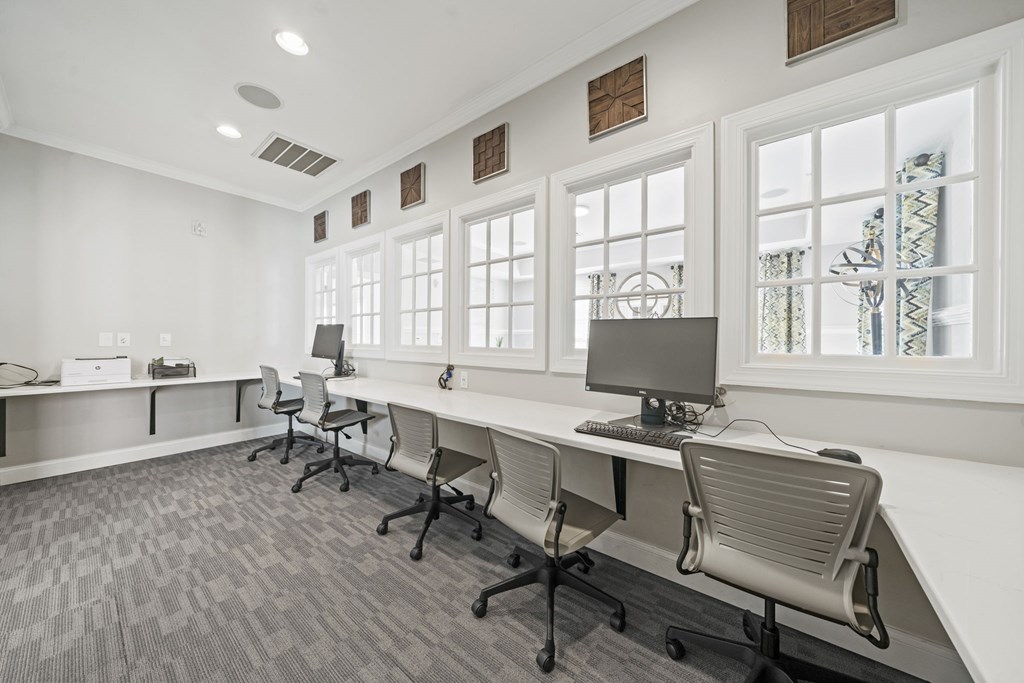A room with a long desk and chairs with a computer on it  at Sterling Manor, Williamsburg, VA