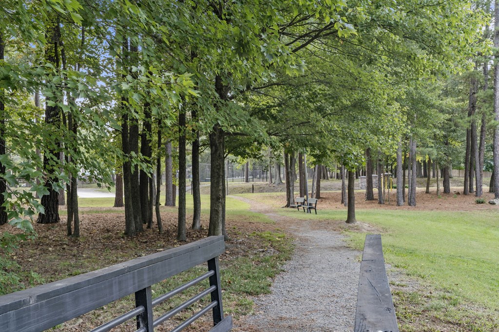a path through a park with trees and a fence at Trails at Short Pump Apartments, Virginia, 23233