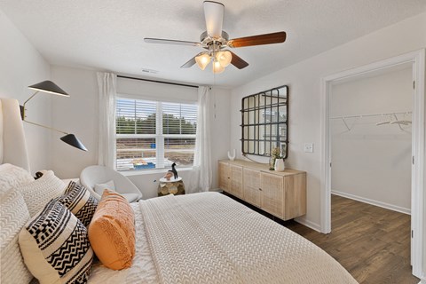 a bedroom with a large bed and a ceiling fan at Summit Place Apartments, Tennessee