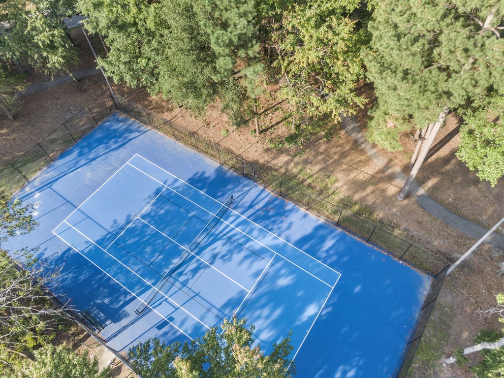 an aerial view of a tennis court surrounded by trees at Trails at Short Pump Apartments, Virginia