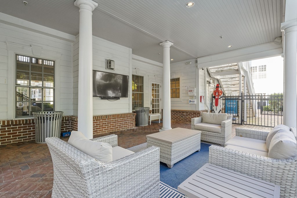 A white wicker sofa set is on a patio with a white ceiling  at Sterling Manor, Williamsburg, Virginia