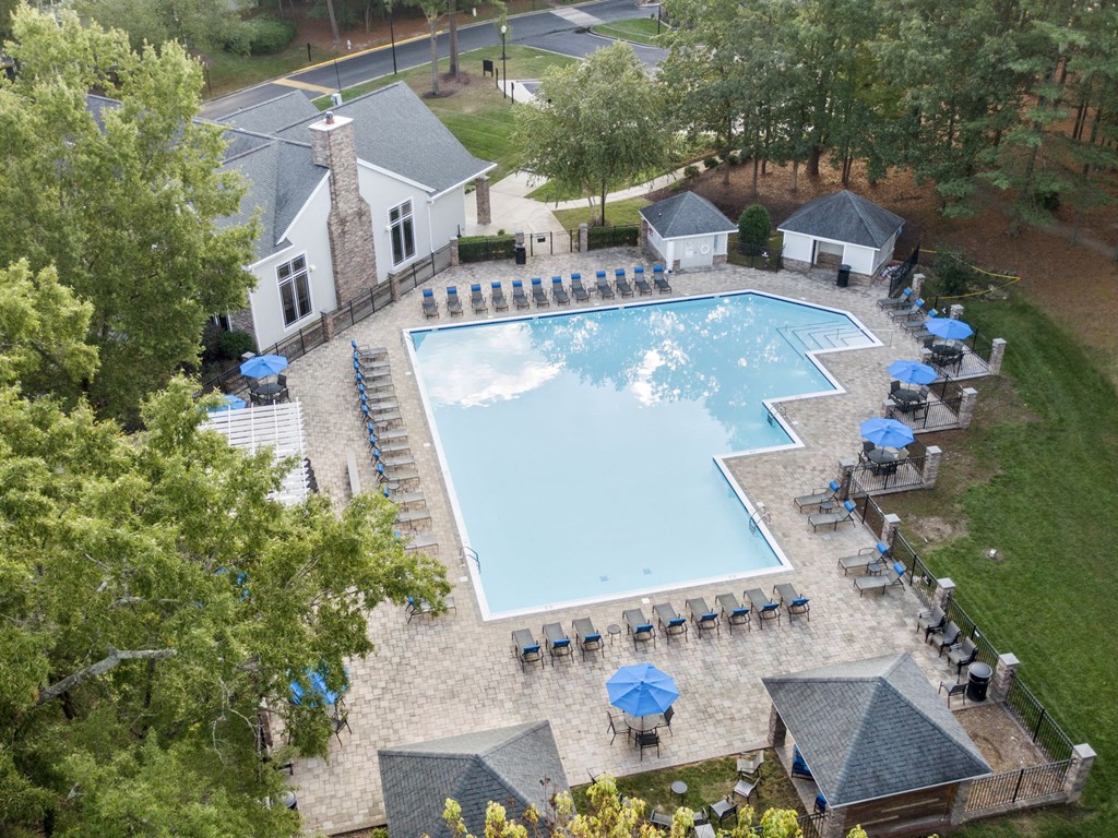 arial view of a swimming pool at a resort with umbrellas at Trails at Short Pump Apartments, Virginia, 23233