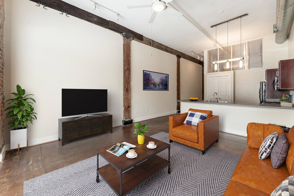 a living room with a couch and a coffee table at Mayton Transfer Lofts in Petersburg, 23803