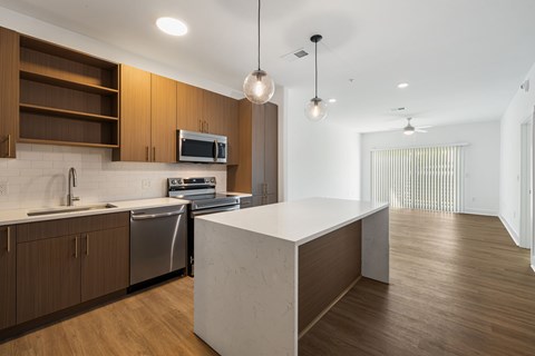 A modern kitchen with wooden cabinets and a white island.
