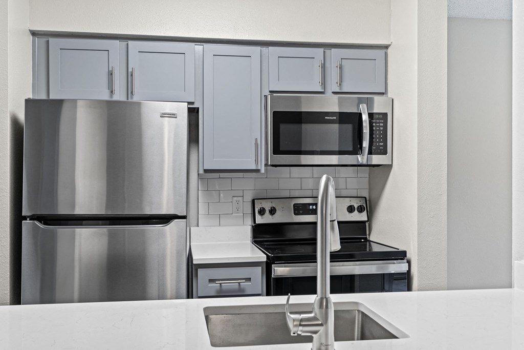 a kitchen with stainless steel appliances and white cabinets at Trails at Short Pump Apartments, Richmond, VA