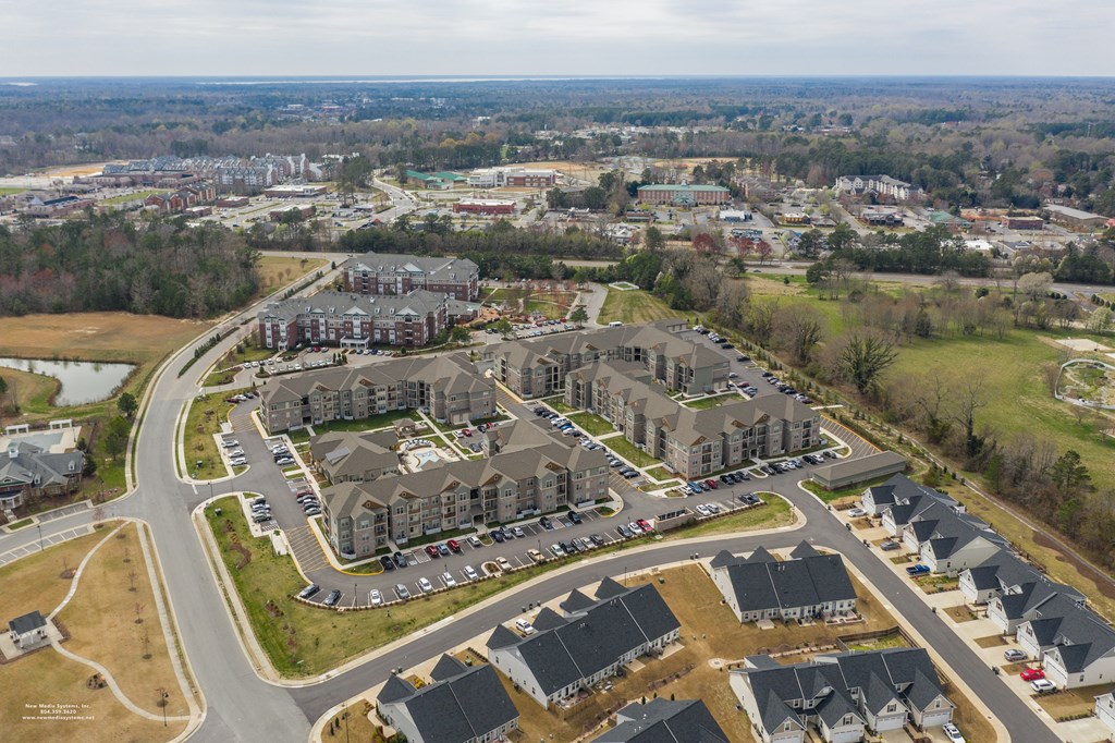 an aerial view of a large complex of houses in a suburb at The Whitworth, Williamsburg, 23185