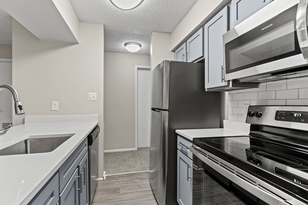 a kitchen with stainless steel appliances and white counter tops at Trails at Short Pump Apartments, Richmond, VA, 23233