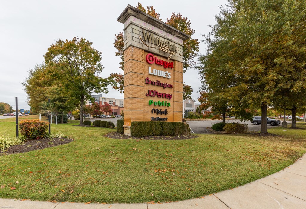 A sign for a place called "Wildwood" stands in a grassy area.