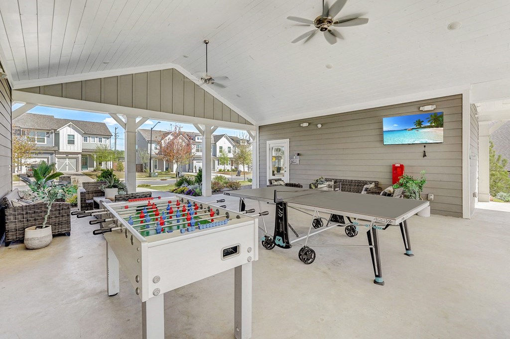 a game room with two ping pong tables