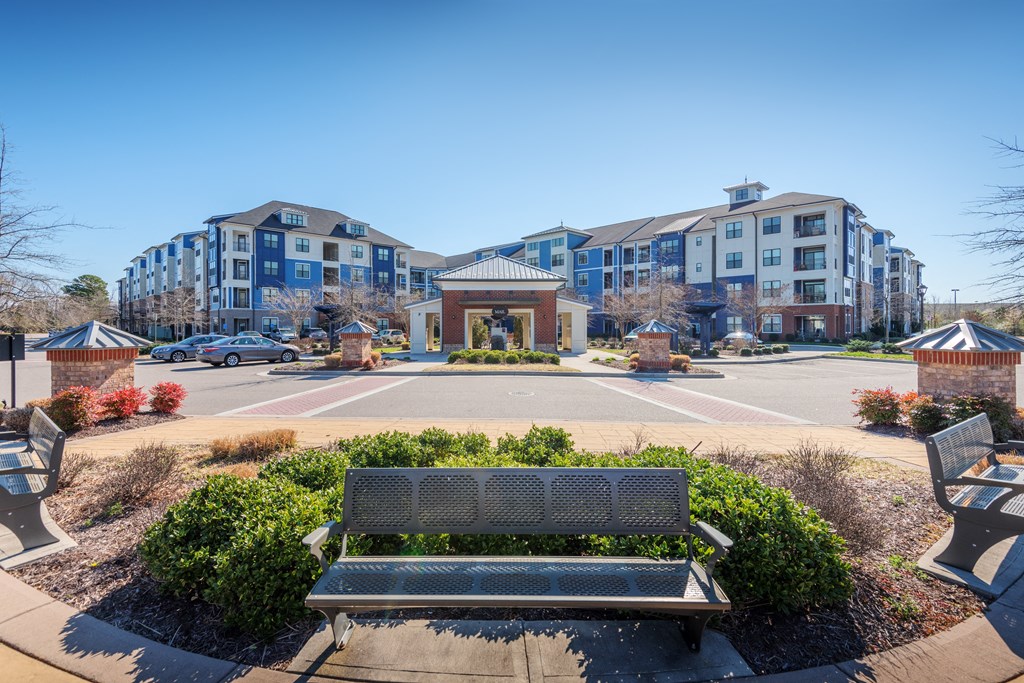 A park with benches and a building in the background at Streets of Greenbrier, Chesapeake, VA, 23320