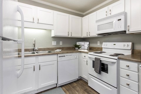 a kitchen with white appliances and white cabinets a kitchen with white appliances and white cabinets at Abbington Place Apartments, Greensboro