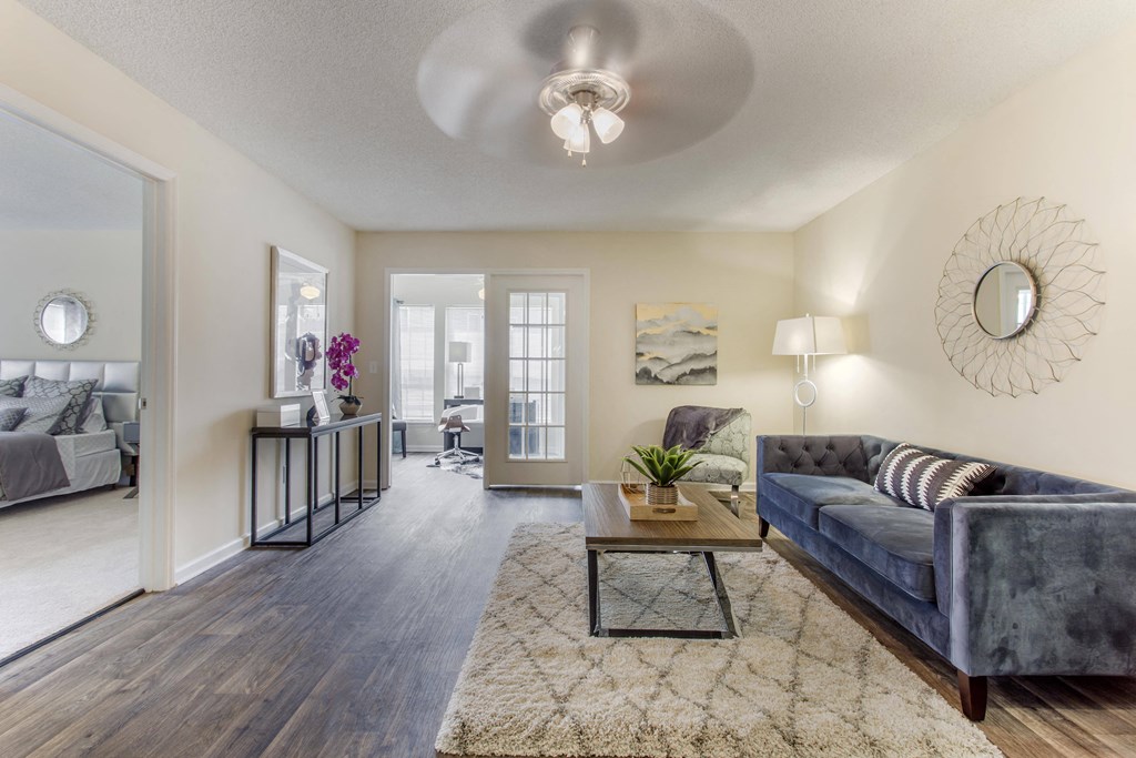 a living room with a couch and a coffee table at Abbington Place Apartments, Greensboro , NC