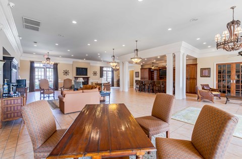 A large, well-lit dining room with a wooden table and chairs.