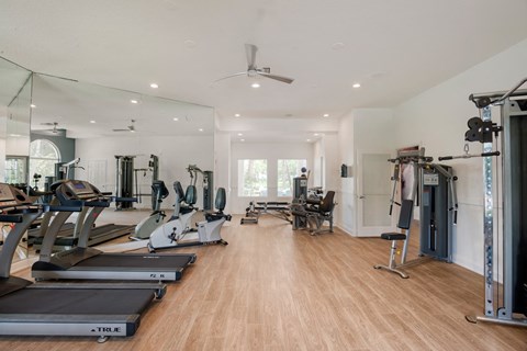 the gym with treadmills and other exercise equipment at the flats at west end at The Villas at Ibis Landing, Parkland