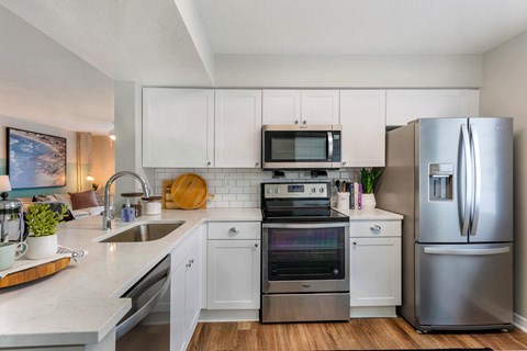 a kitchen with stainless steel appliances and white cabinets