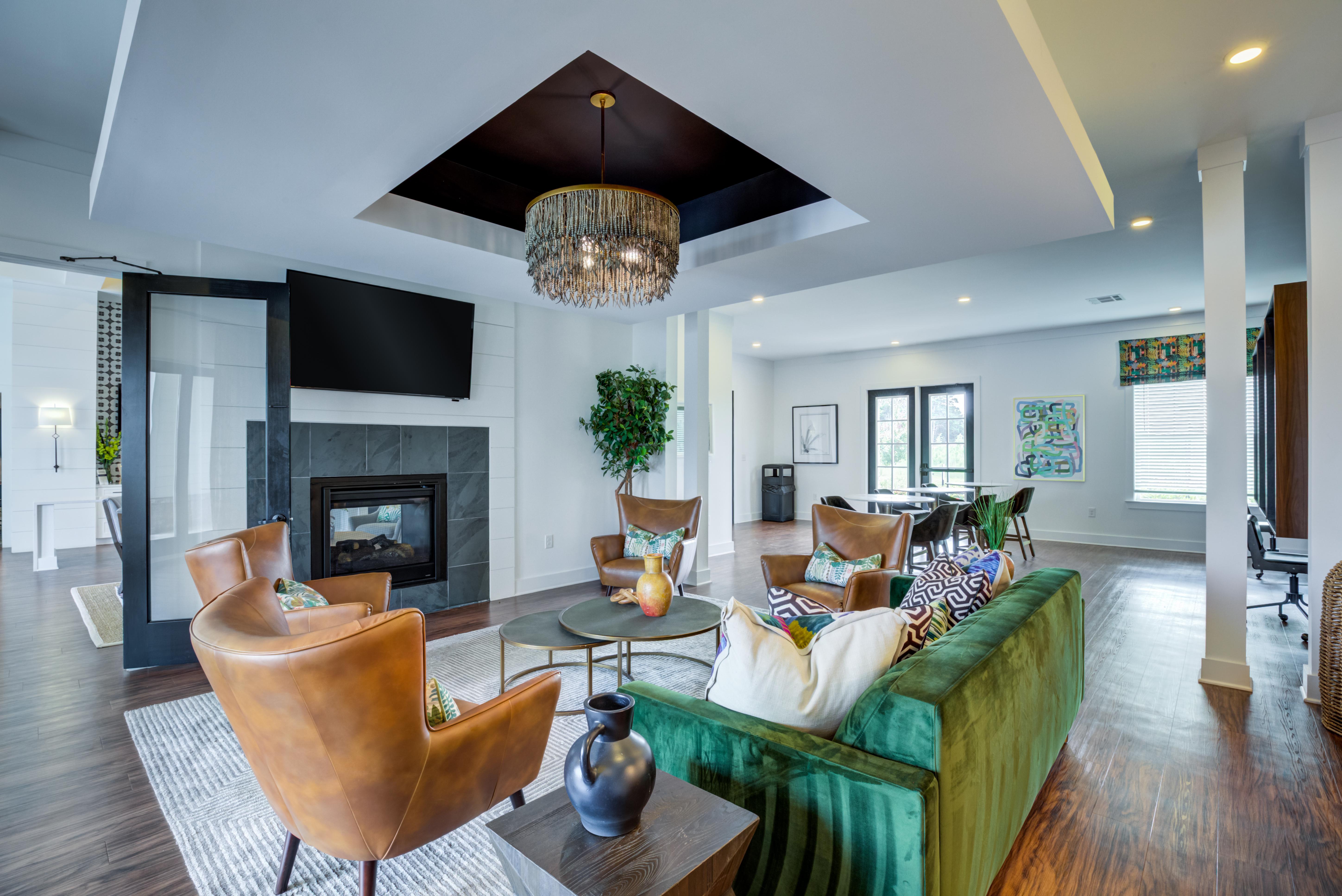 A living room with a green couch and a fireplace.
