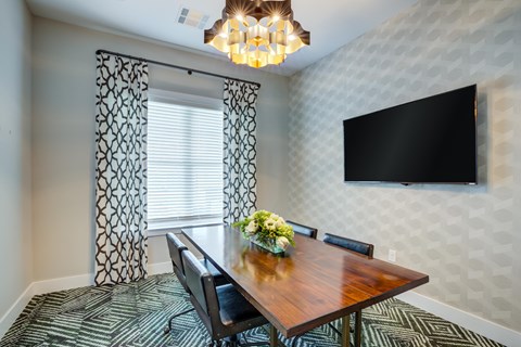 A dining room with a wooden table and chairs.
