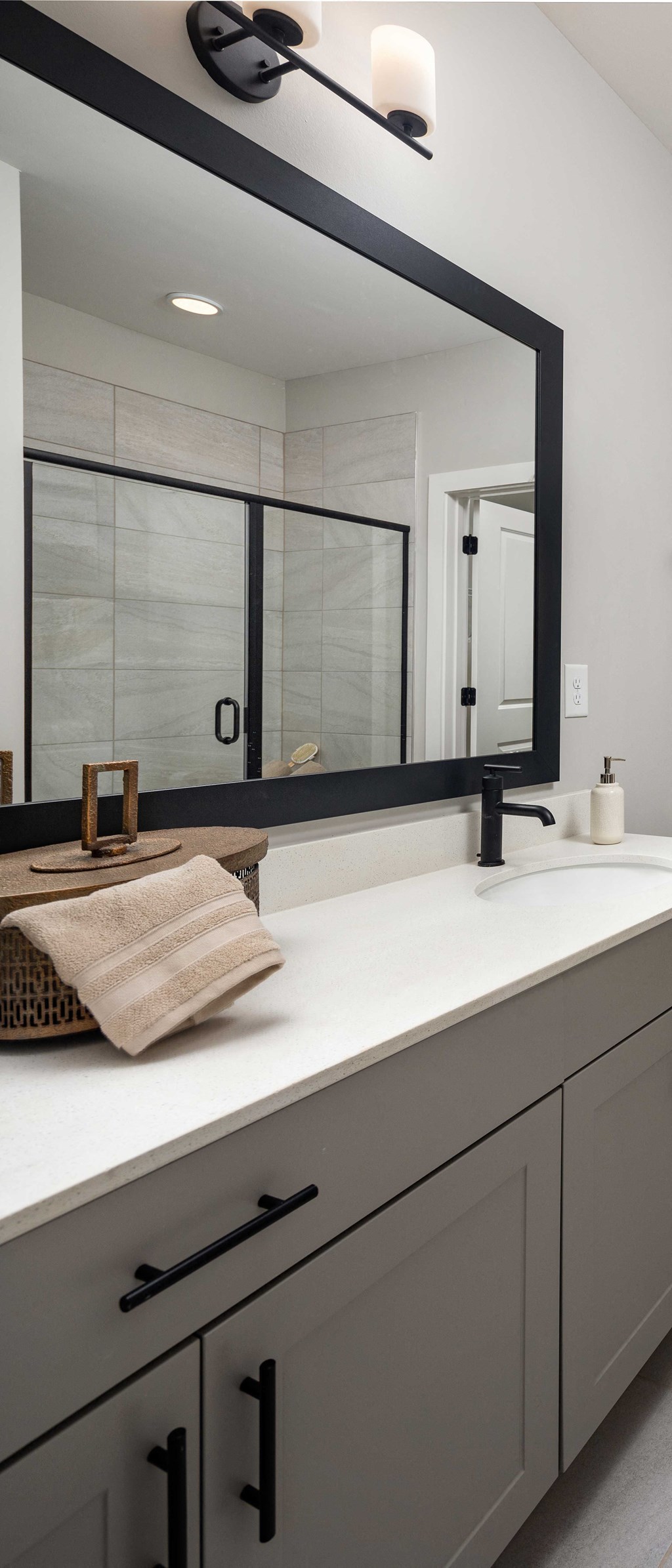 a modern and funky half bathroom reveal with black and white tile in a modern laundry space at The Flats at Southlawn Apartments, Lawrenceville Georgia