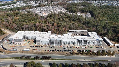 A large white building with a parking lot in front of it.