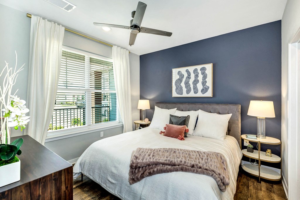 a bedroom with a large bed and a ceiling fan at Farmhaus Apartments, Madison, AL, 35757