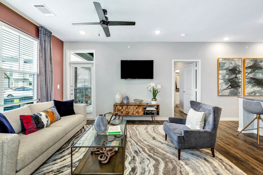 a living room with a couch and a chair at Farmhaus Apartments, Madison