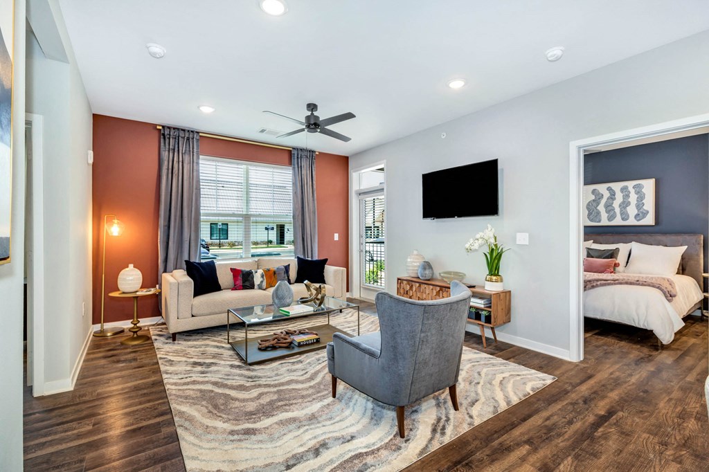 a living room with a couch and a chair at Farmhaus Apartments, Alabama