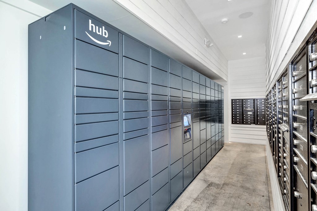 a row of blue lockers in a room with wine racks at Farmhaus Apartments, Madison, AL, 35757