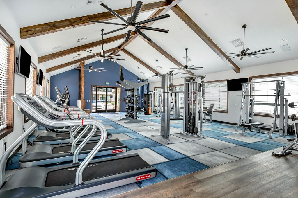 an aisle of chairs in a building with ceiling fans at Farmhaus Apartments, Alabama