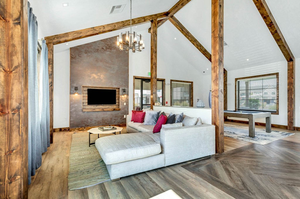 a living room with a white couch and a fireplace at Farmhaus Apartments, Madison, AL