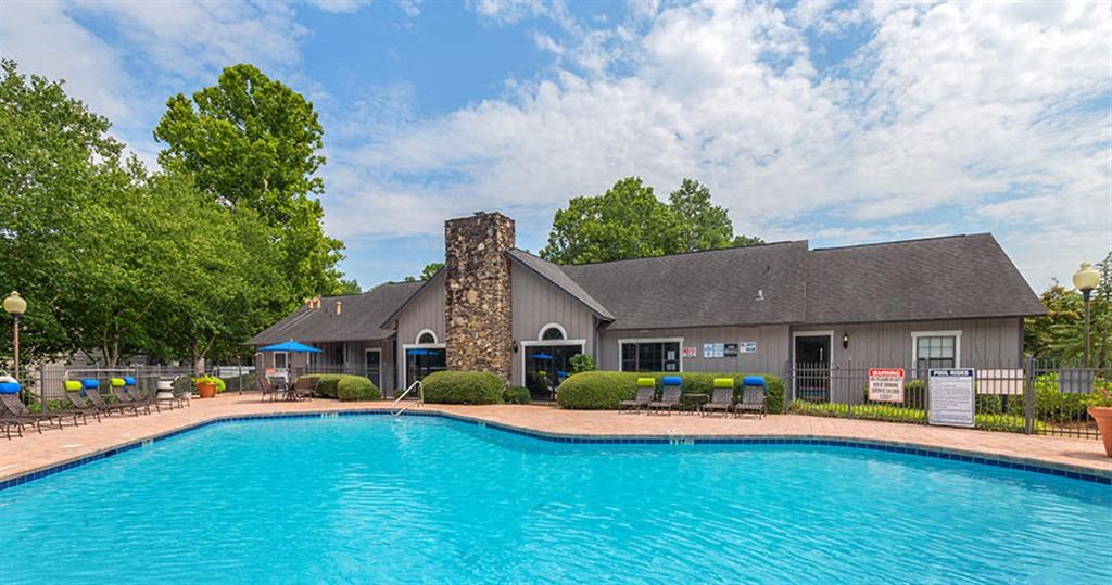 a large swimming pool in front of a house at High Ridge Apartments, Athens Georgia