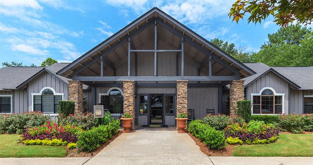 the front of a building with a sidewalk and landscaping at High Ridge Apartments, Georgia, 30606