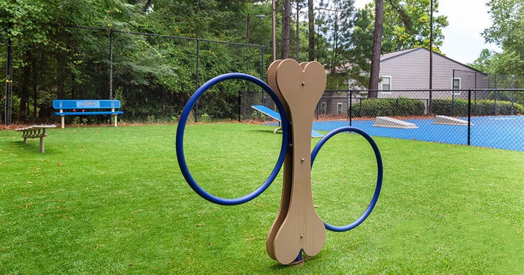 a playground with a hula hoop on the grass at High Ridge Apartments, Athens, GA