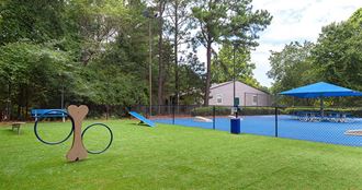 a playground with a tennis court and a swing set at High Ridge Apartments, Athens, GA 30606