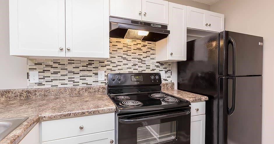 A kitchen with a black stove and refrigerator. A kitchen with a black stove and refrigerator. at Bradford Pointe, Augusta, GA
