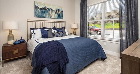 a bedroom with a bed and a window at The Flats at Southlawn Apartments, Lawrenceville Georgia