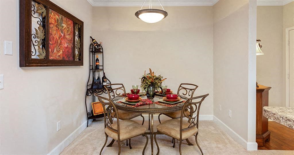 a dining room with a table and chairs a dining room with a table and chairs at Bedford Parke Apartments, Georgia, 31088